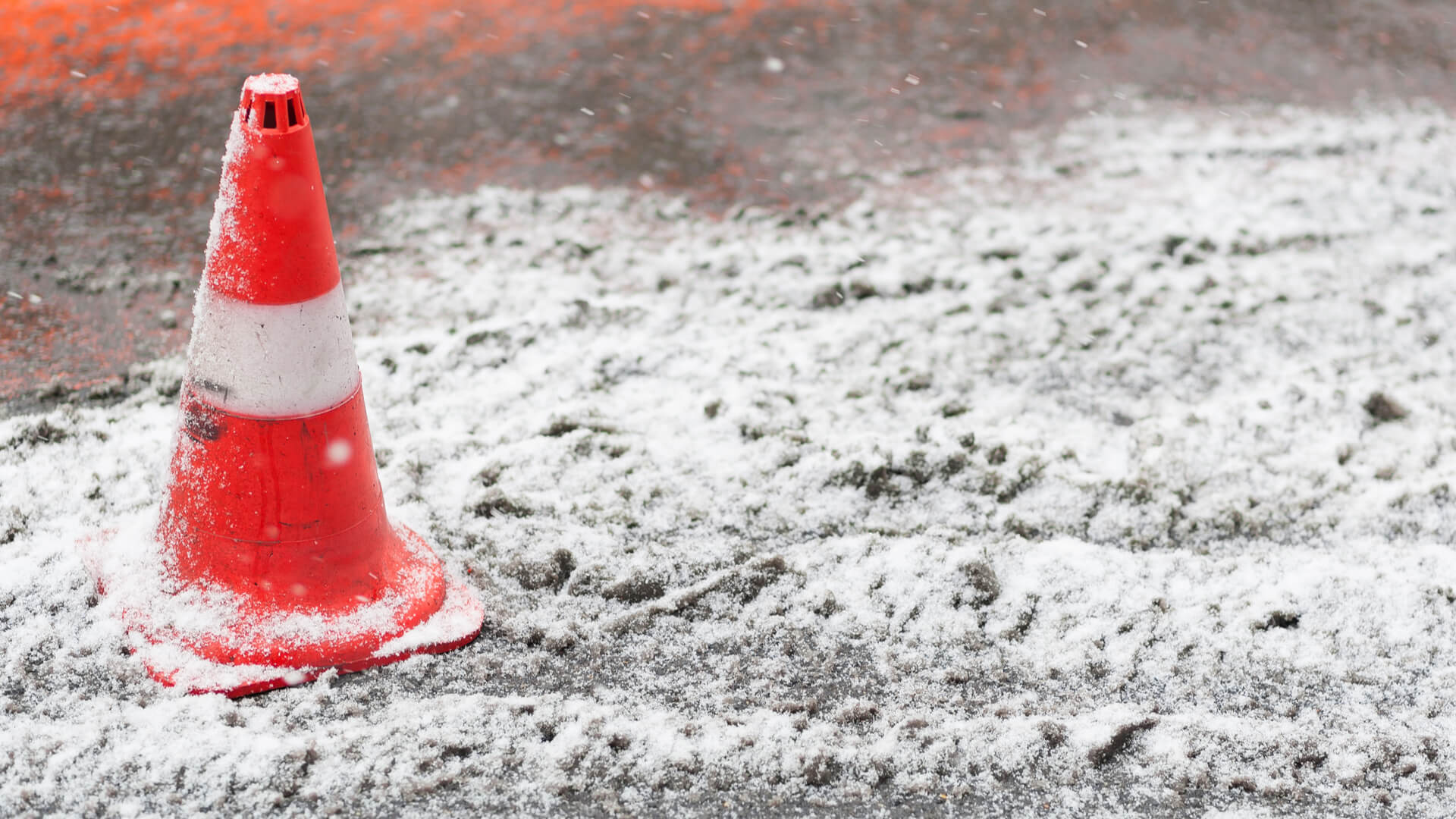 Snow that has been gritted with orange cone to warn of danger (1)